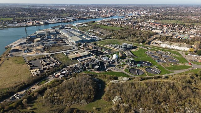 Aerial view of the industrial landscape meeting the serene riverbanks near Anglian Water Cliff Quay WRC, Ipswich, United Kingdom.