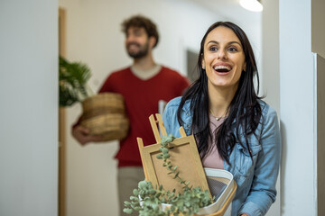 Portrait of a happy young woman walking into her new apartment for the first time.