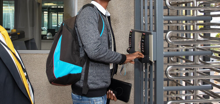 Person using electronic access control at high security turnstile entrance