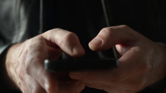 Male hands using smartphone, close up 4K