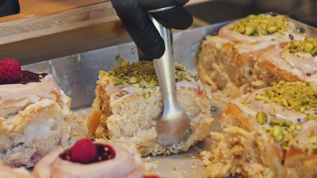 Freshly baked cinnamon rolls and berry and pistachio. Bakery products. Appetizing cinnamon buns with berry jam and pistachio cream. High quality 4k footage