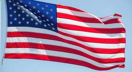 Fototapeta premium American flag waving against a clear blue sky 