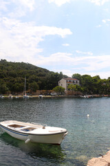 Fototapeta premium Small boat is moored in idyllic bay on island Lastovo, Croatia.