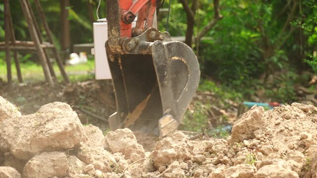 Excavator digging construction soil dirt machinery outdoor earth engineering equipment heavy earthmoving machinery digging soil rock and dirt outdoor construction site with rugged ground foundation