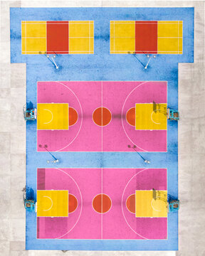 View of the colorful basketball and badminton courts at Choi Hung Estate with vibrant pink, yellow, and blue surfaces in Hong Kong.