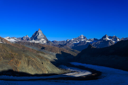 Mountain panorama with summits Matterhorn, Dent Blanche and Ober Gabelhorn and glacier Grenzgletscher seen from Monte Rosa Hut in the morning in Pennine Alps, Switzerland