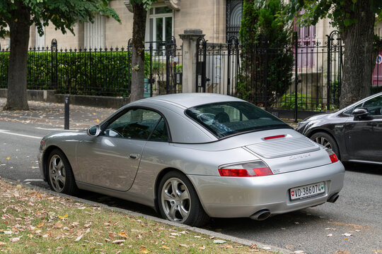 Nancy, France - July 9th 2025 : View on a grey Porsche 996 Carrera 4 Cabriolet with a hardtop parked on a street.