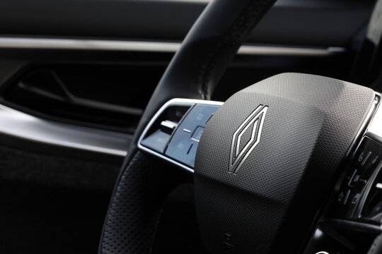 Renault  logo.  Close-up view of a modern car steering wheel with sleek design elements. Paris, France - 26 march 2026.