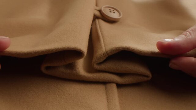 Beige wool background, natural sheepskin close-up macro coat. Top view