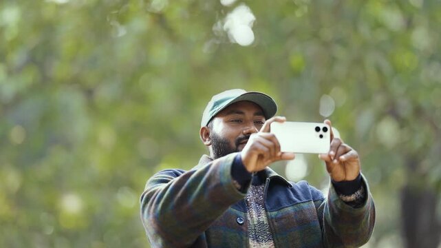 Man capturing moments on smartphone, testing camera quality while shooting photos and videos, casual hobby vibes, modern mobile photography in everyday life, hand closeup, capturing photos