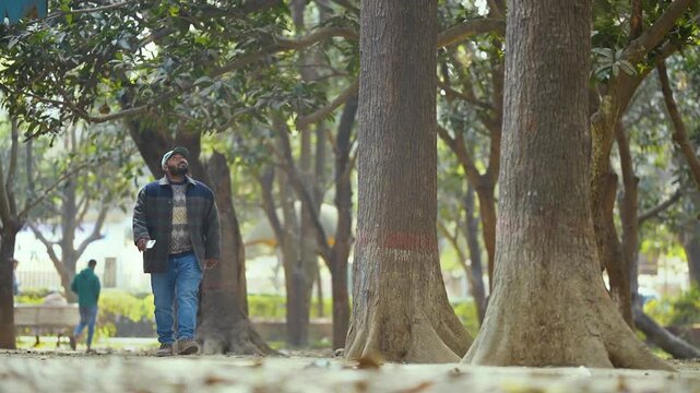 Man walking with smartphone, casual moment of a man walking while holding a smartphone, everyday lifestyle vibe, modern connection, natural light, candid feel, relatable and simple story