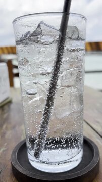Soda water fizzing bubbles on the clear glass