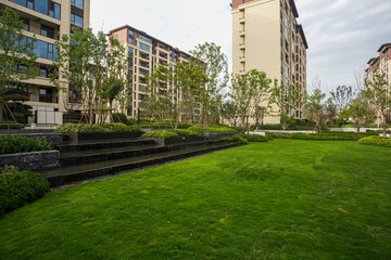 Fototapeta premium Modern residential park with green lawn and cascading water feature - Community peace concept