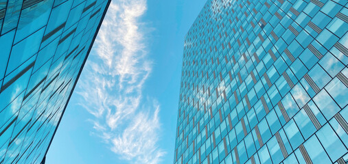 Office building. Skyscrapers in business center. Modern architecture, glass curved facade of residential or commercial real estate, blue sky background © rohappy