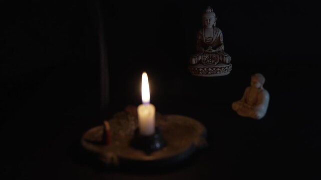 Candle and Buddha statue