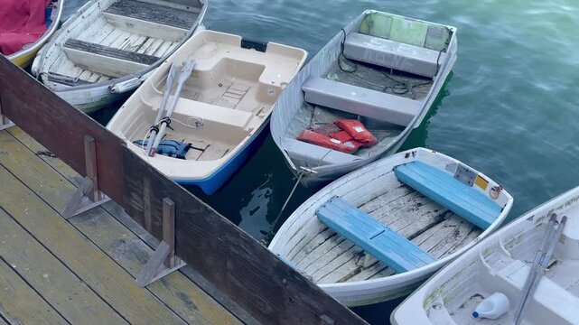 Small Rowboats and Dinghies Moored at a Wooden Pier