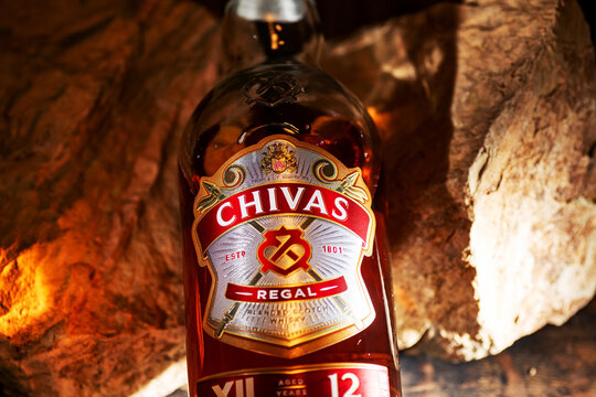 Premium Chivas Regal scotch whisky bottle with amber color and detailed label