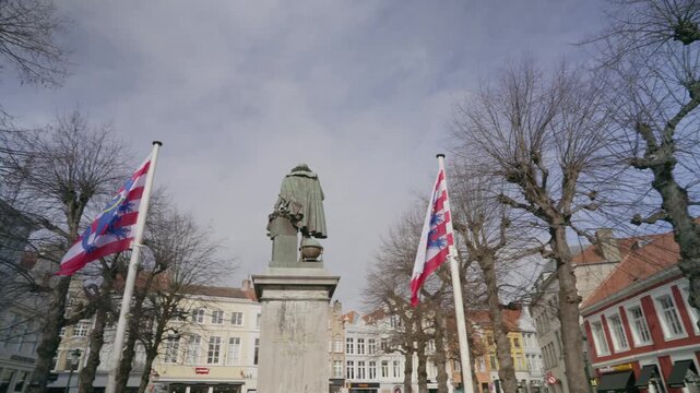 Jan van Eyck statue in Jan van Eyckplein square in Bruges, Belgium