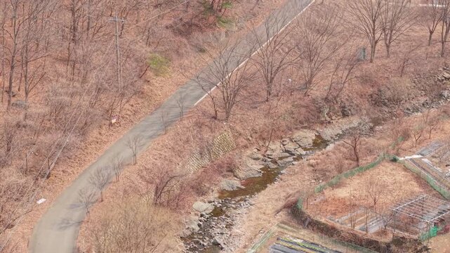 Cinematic motorcycle riding on Scenic route with a mountain creek with synchronized real exhaust sound_Telephoto