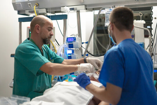 Medical team intubating critically ill patient in icu
