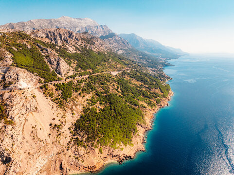 Aerial panoramic view of Makarska Riviera with turquoise Adriatic sea and Biokovo mountain range in the background, Dalmatia, Croatia.