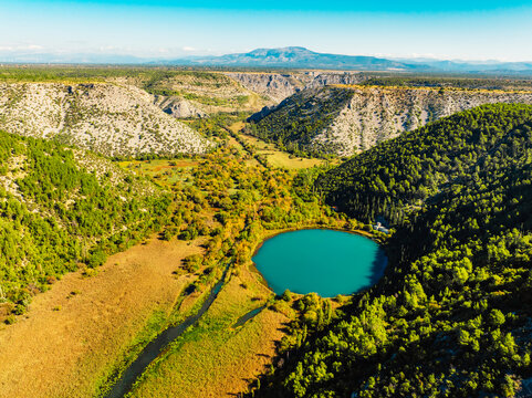 Aerial view of the confluence where the Cikola river lake drom torak view tributary joins the Krka river canyon, Krka National Park, Dalmatia, Croatia.