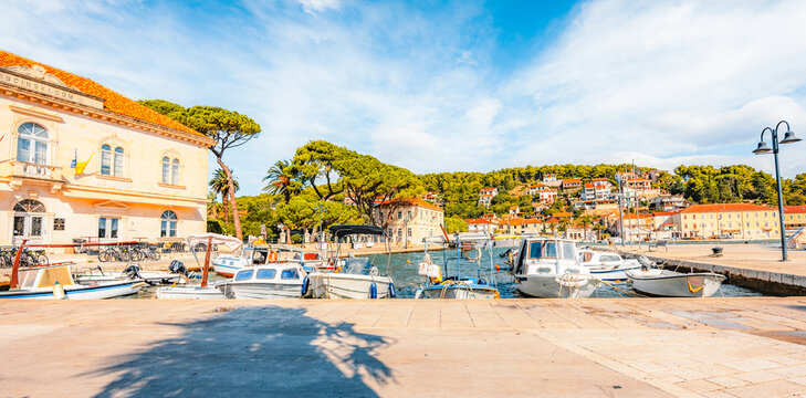 Jelsa town on Hvar island, with traditional Dalmatian stone architecture and boats moored in the harbor, Croatia.