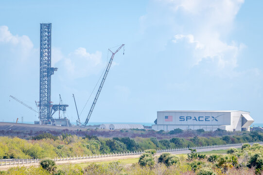 A rocket assembly facility and future SpaceX Starship launch tower under construction at Cape Canaveral, FL