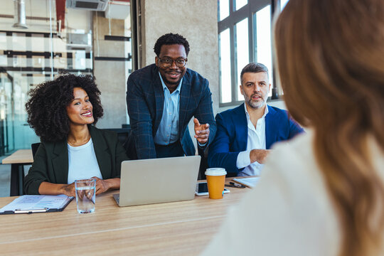 Diverse Business Panel Interviewing Candidate in Modern Office During Professional Meeting