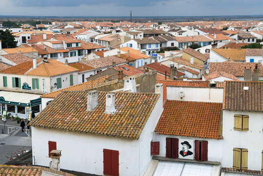 View of rooftops in Saintes-Maries-de-la-Mer showing traditional architecture and the landscape beyond in France