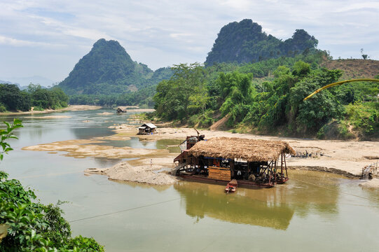 Gold diggers operate a barge on the Lo river in Ha Giang province of Vietnam during daylight hours