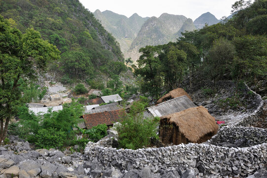 Hamlet village in the mountains of Dong Van plateau with traditional houses and rocky landscape in Northern Vietnam