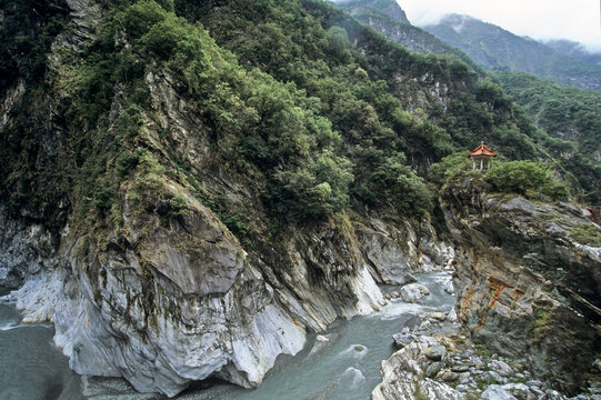 Explore the natural beauty of Taroko Gorge with steep cliffs and flowing river in Taiwan's famous national park
