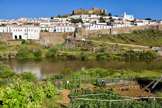 View of Mertola above the Guadiana River from the opposite bank in Alentejo region, Portugal under clear sky