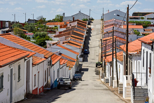 Picturesque street lined with white houses and red roofs in a village of Beja, Alentejo region, Portugal