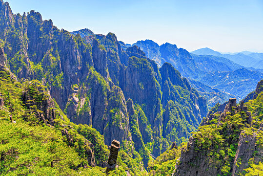 View of rugged mountain peaks with green trees in Huangshan, a UNESCO site in Anhui Province, China