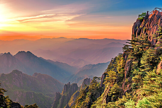 Sunrise reveals the beauty of Huangshan as the sky changes colors over the mountains