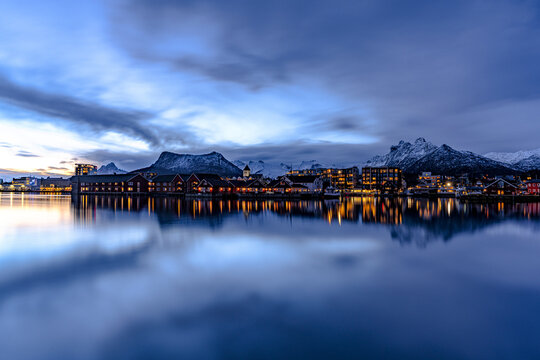 Dusk time in Svolvaer with town lights reflecting in the sea in Norway&acirc;&euro;&trade;s Lofoten Islands