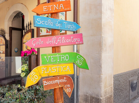 Direction sign post in Ragusa Ibla showing various locations in Sicily, Italy