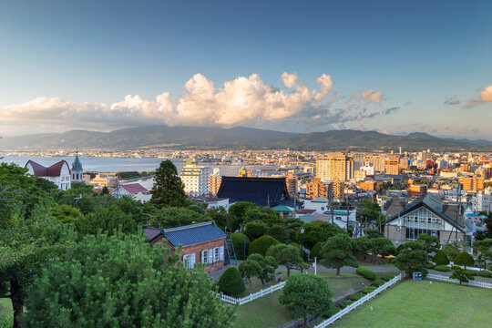 View of Motomachi area with buildings and mountains in Hakodate, Hokkaido, Japan during sunset