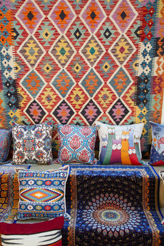 Explore carpets and pillows for sale in Kaleici market in Antalya Province, Turkey showcasing rich colors and patterns for home decor