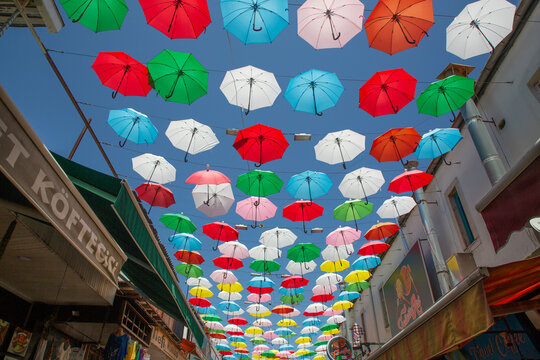 Colorful umbrellas hanging over a lively street in Antalya, Turkey showcasing a vibrant and festive atmosphere
