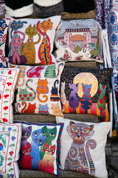 Colorful pillows for sale at Arasta Bazaar showcasing various cat designs in Istanbul, Turkey