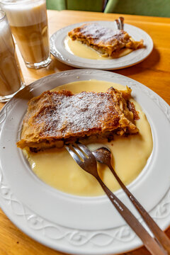 Enjoying apple strudel at Krimml Waterfalls in Hohe Tauern National Park in Salzburg, Austria, during a sunny afternoon