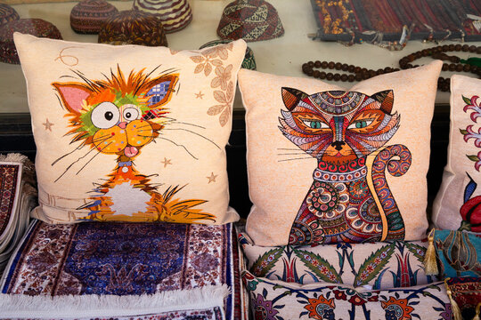 Unique decorative pillows showcasing cat designs for sale in Istanbul's Arasta Bazaar