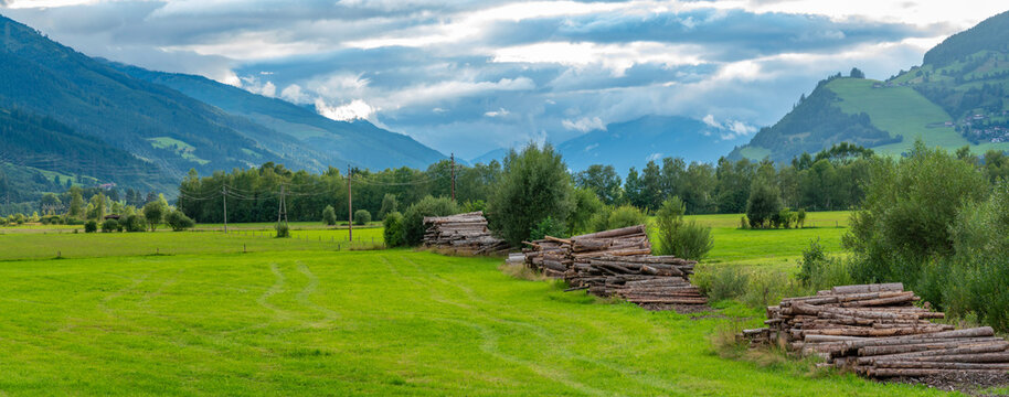 View of summer landscape near Kaprun with logs and green fields in Salzburg, Austria