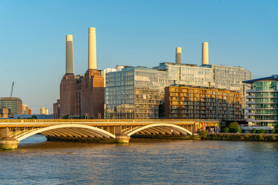 View of Battersea Power Station and River Thames in summer from Nine Elms in London, England, with clear skies and modern buildings nearby