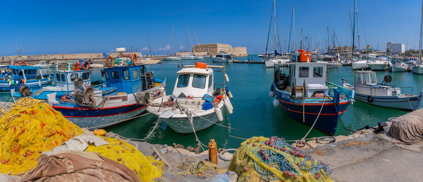 Vessels docked at Koules Venetian Fortress in Heraklion Port on a bright sunny day in Crete