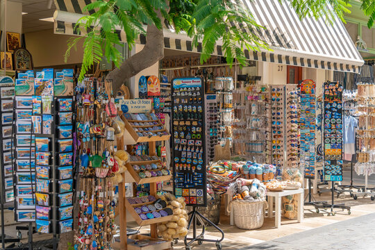Souvenir shop displays various items for tourists in the city center during a sunny day in Heraklion