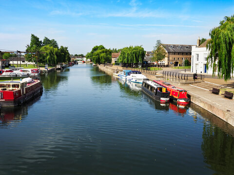 Boats docked along the River Great Ouse in Ely Cambridgeshire during a clear day in late spring